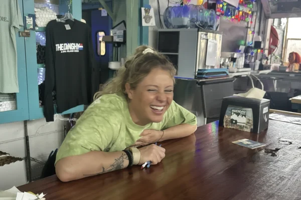 Female, barkeep, geeking out, green shirt
