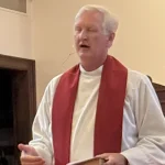 DeepWater Church pastor saying prayer at LENS event.
