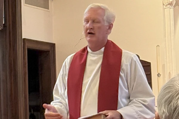 DeepWater Church pastor saying prayer at LENS event.