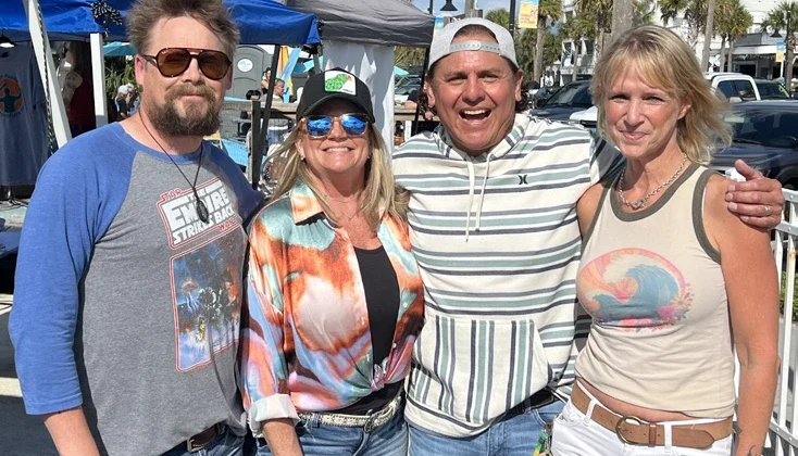 Two couples posing for a photo at an Isle of Palms' Songwriters Festival