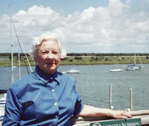 Vintage photo IOP, SC's first female Mayor resting her arm on the edge of a dock.