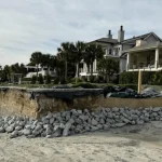 Picture taken from the dunes of a beach front property's eroding foundation and what they're doing to combat it.