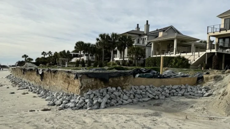 Picture taken from the dunes of a beach front property's eroding foundation and what they're doing to combat it.