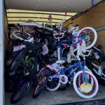 Looking at a lot of bikes piled into a U-haul truck.