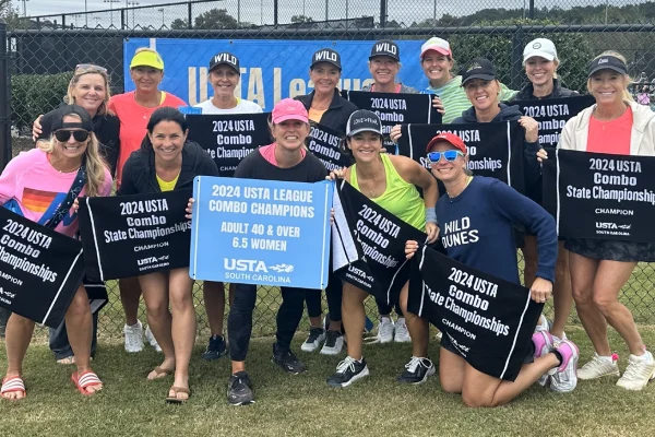 Wild Dune's women's tennis team showing off their South Carolina championship title.