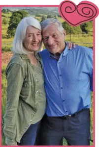 The Harringtons in front of a wine vineyard.