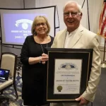 IOPSC's newest Town Council Member and his wife showcasing his 2024 Palmetto Award.