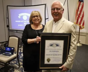 IOPSC's newest Town Council Member and his wife showcasing his 2024 Palmetto Award.