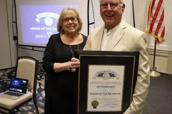 IOPSC's newest Town Council Member and his wife showcasing his 2024 Palmetto Award.