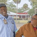 IOPSC's mailman and his wife smiling, ear to ear.