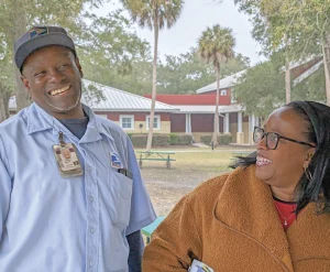 IOPSC's mailman and his wife smiling, ear to ear.