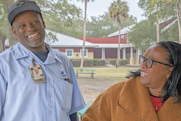 IOPSC's mailman and his wife smiling, ear to ear.