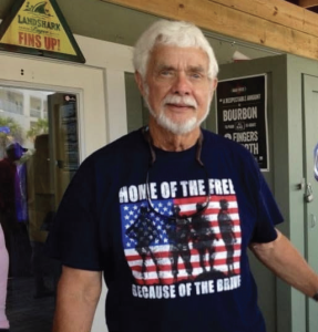 White haired caucasian male wearing American veterans t-shirt