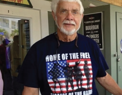 White haired caucasian male wearing American veterans t-shirt