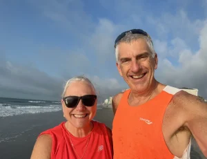 Selfie photo of the Crance couple amidst a beachwalk.