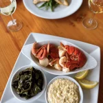 Two chef prepared seafood dinner plates at IOPSC's Boathouse restaurant.