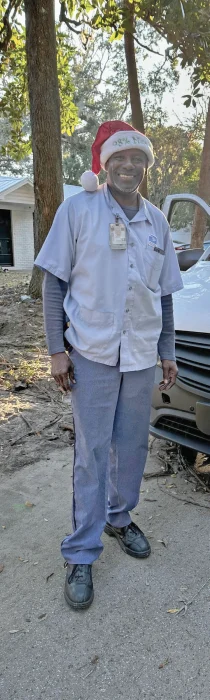 Full body shot of a US postman in his USPS uniform.