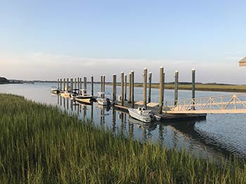 A pier with boats on Dewees Island, SC.