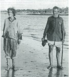 A black and white photograph of the Halloways walking on the beach of Goat Island.