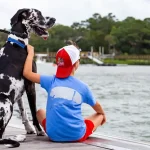 Lilly and John David on a dock at Morgan Creek in front of the Islander 71 restaurant.