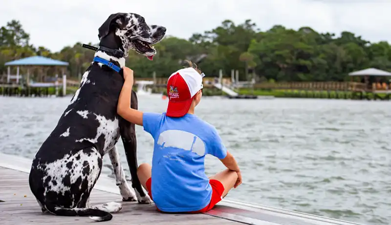 Lilly and John David on a dock at Morgan Creek in front of the Islander 71 restaurant.