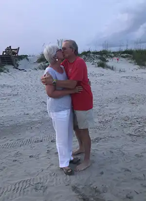 Maree and Buddy share a kiss on the beach at IOP, SC