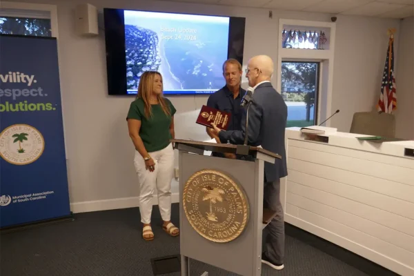 Islander 71 staff receiving their Isle of Palms' Signal 30 Award from IOP Mayor Phillip Pounds