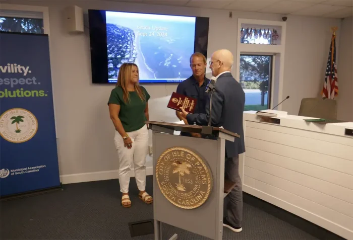 Islander 71 staff receiving their Isle of Palms' Signal 30 Award from IOP Mayor Phillip Pounds