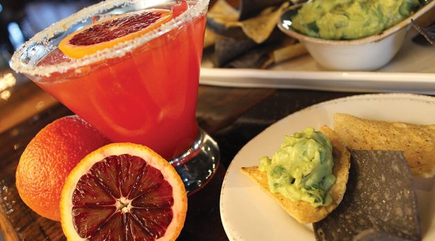 a margarita with chips and guacamole at SOL Southwest Kitchen & Tequila Bar