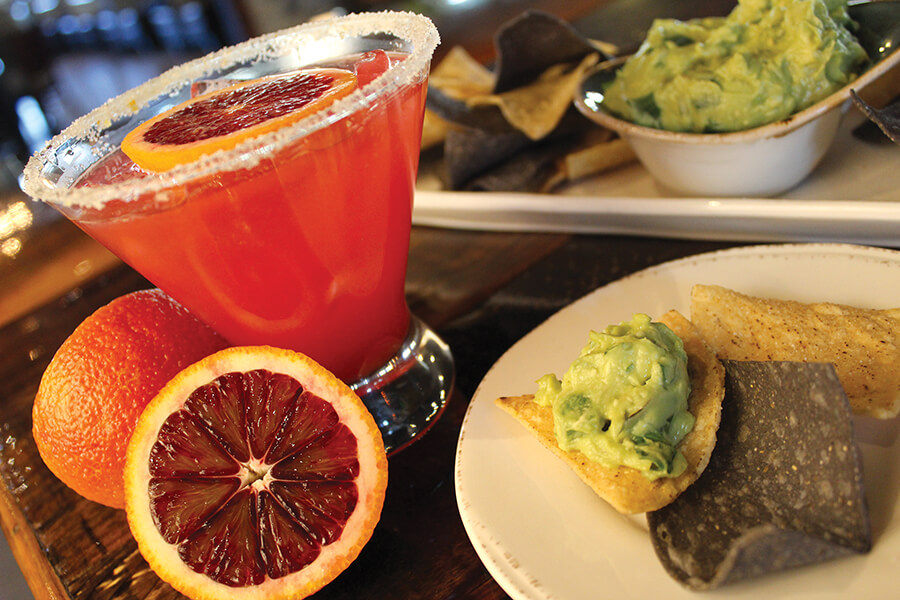 a margarita with chips and guacamole at SOL Southwest Kitchen & Tequila Bar