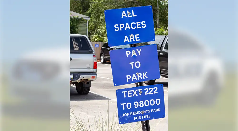 Parking Signs: All spaces are pay to park. Text 2222 to 98000. IOP residents park for free.