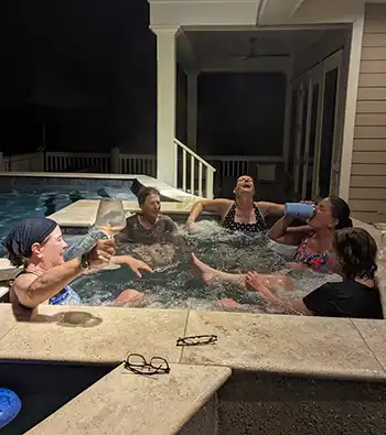 The group of college friends, mostly from Boston, enjoys the hot tub in an Isle of Palms vacation rental.